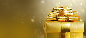 Eine goldene Geschenkbox mit Schleife.