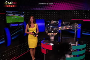 Zu sehen ist die Dealerin neben einem Automaten der zufällige Zahlen auf Bällen mithilfe von Luftdruck ermittelt.