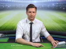 Das Bild zeigt einen Live Dealer, der das Spiel Football Studio von Evolution Gaming im Live Casino von Vegas Hero anleitet.